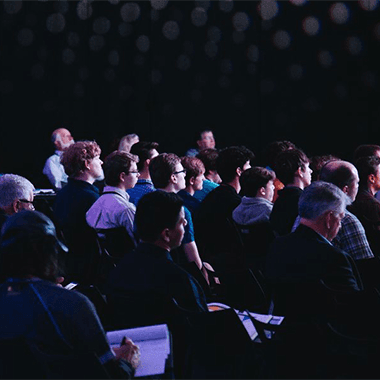 Picture of group of people sitting in event hall